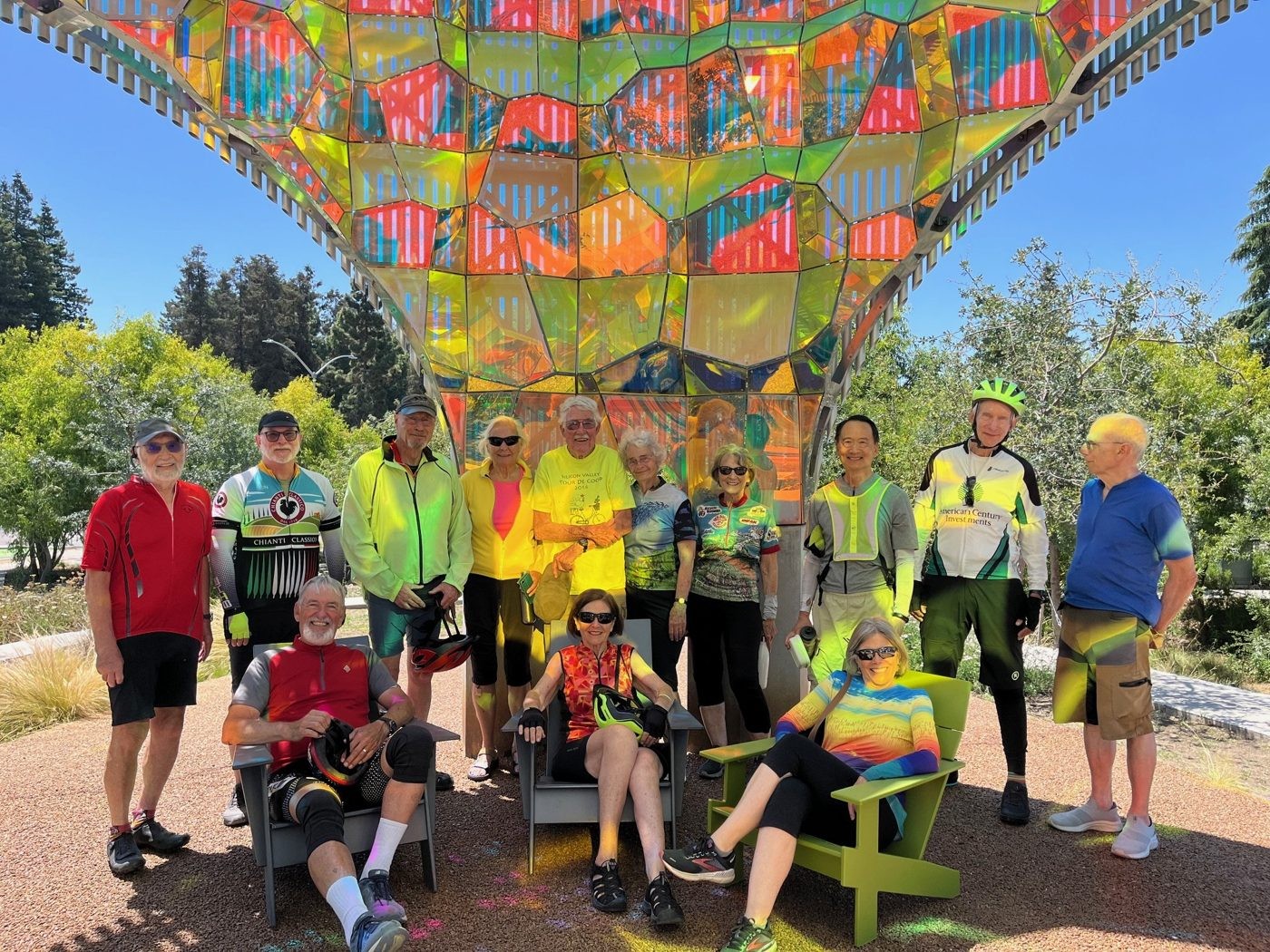 Senior Spokes group photo under a colorful sculpture