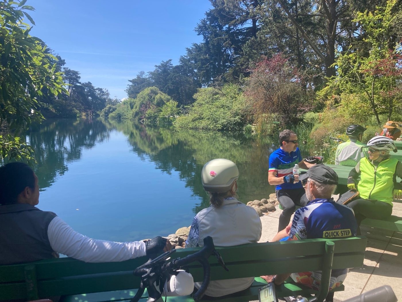 Senior Spokes riders resting by a pond on the trail